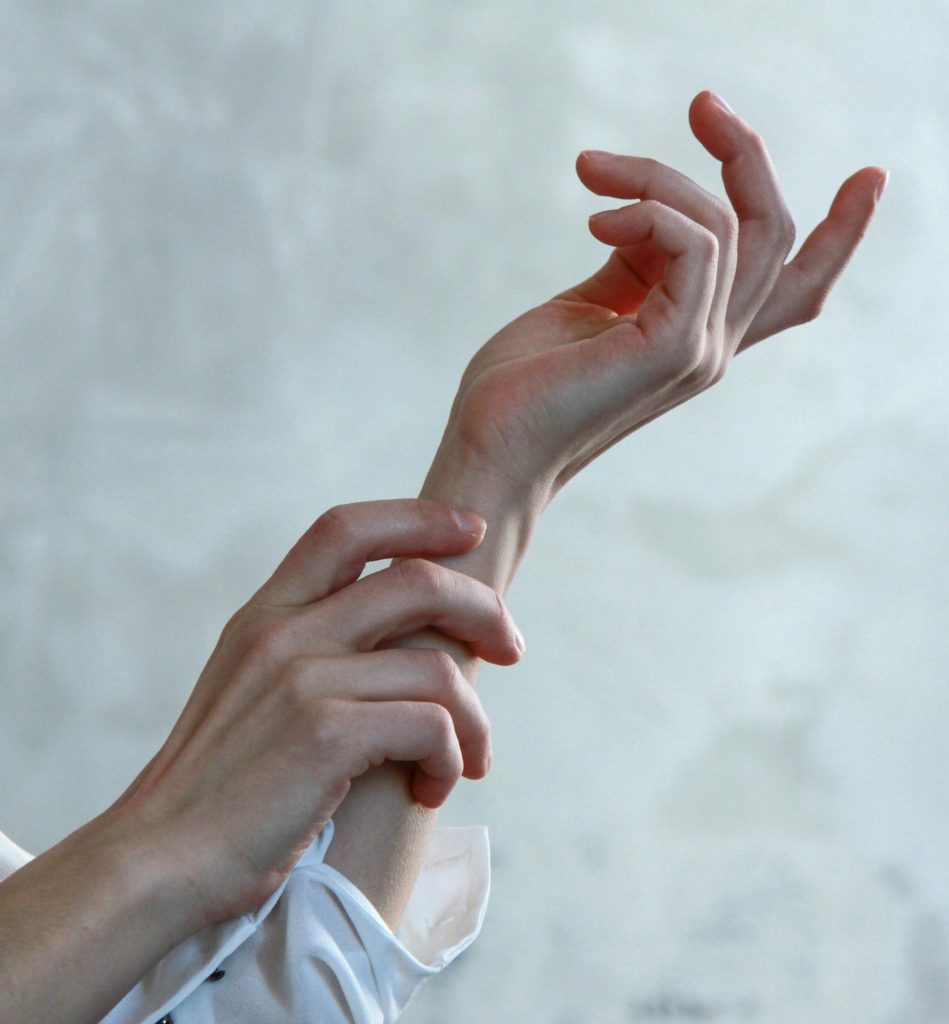 A close-up of elegant female hands in soft natural light, creating a minimalist and artistic aesthetic.